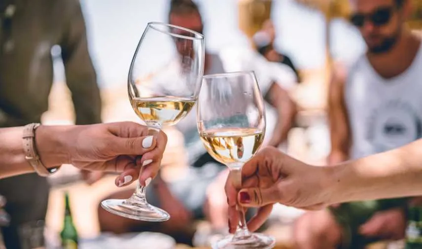 Friends clinking wine glasses together